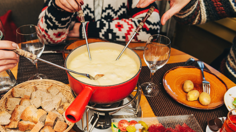 People enjoying Swiss cheese fondue