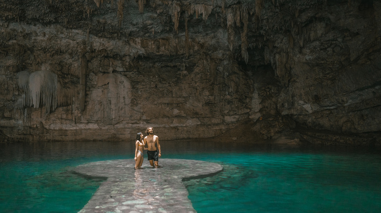 Couple standing in a cenote