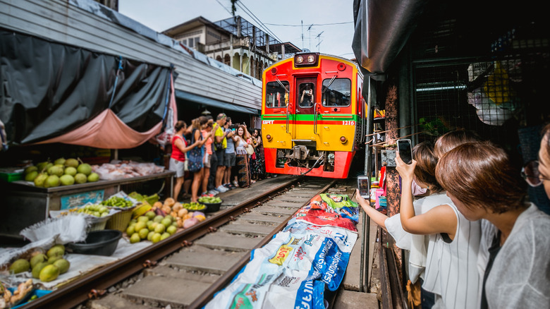 Tourists taking pictures of train