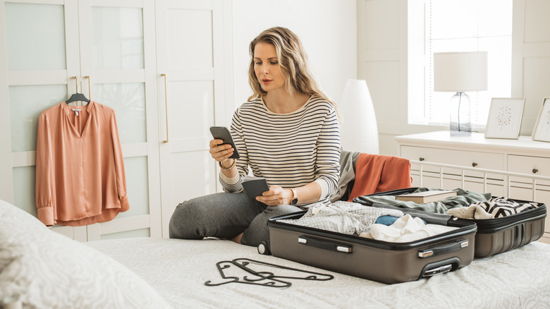 Woman packing suitcase