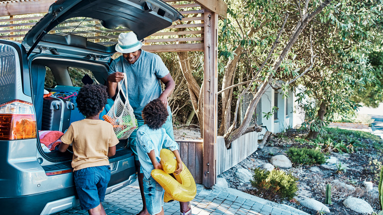 A dad packing for a trip with his kids