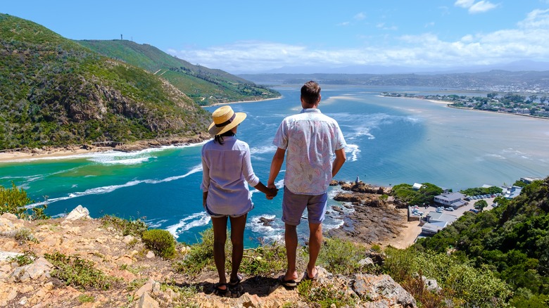 Couple standing at coastal viewpoint