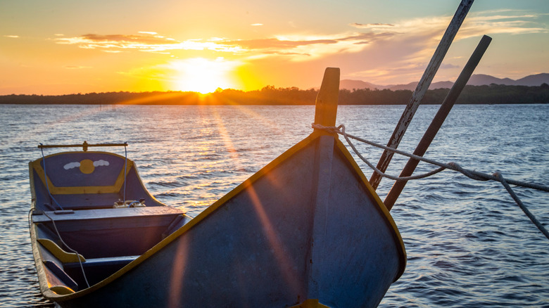 Rustic wooden boat against sunset
