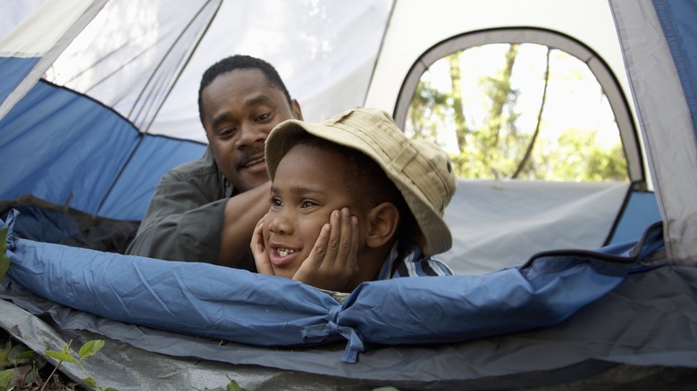 Father and son in a tent