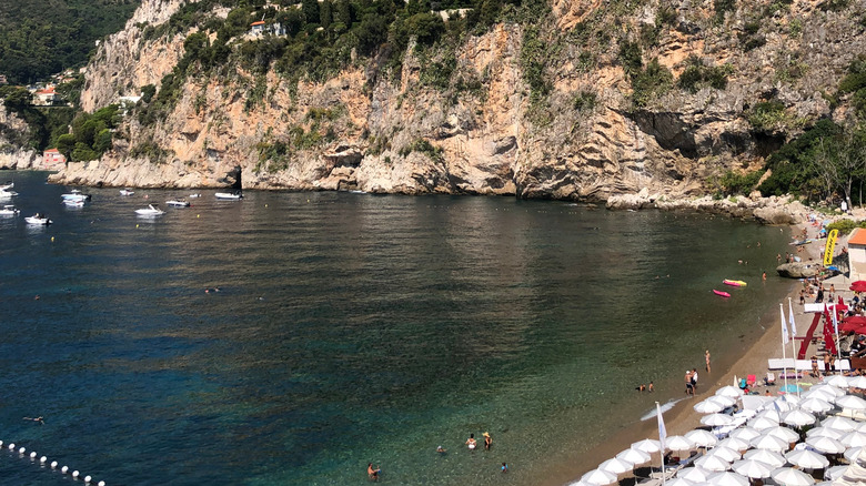 people and boats in bay