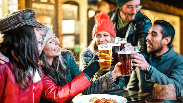 group with beer in winter clothes