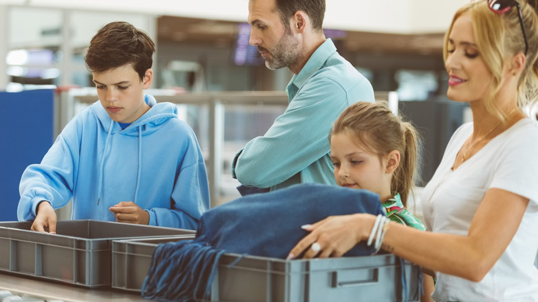 family in airport security checkpoint