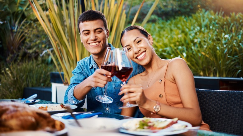 couple clinking wine glasses