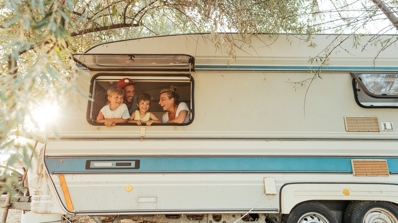 Family looking out RV window