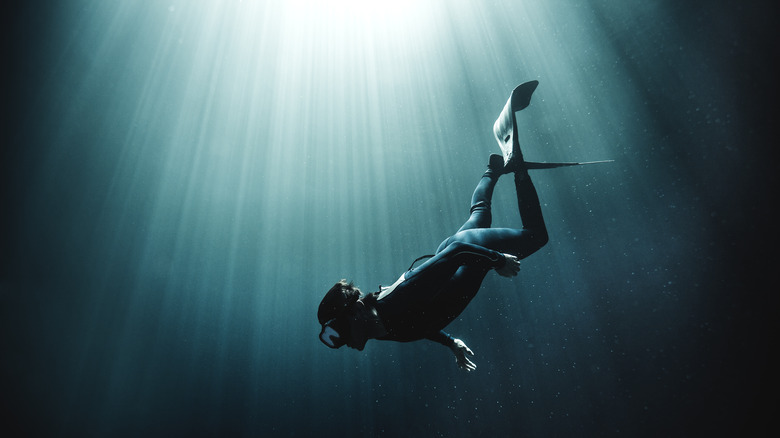 Scuba diver bathed in light