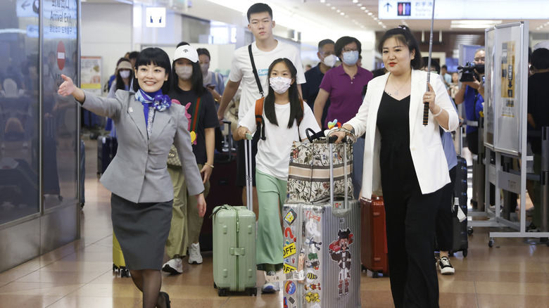 Haneda airline staff guiding tourists