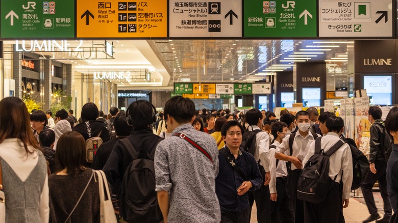 Commuters Shinjuku Station directional signs