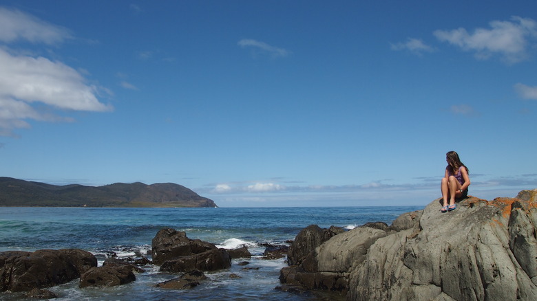 Woman on rock in Bruny Island