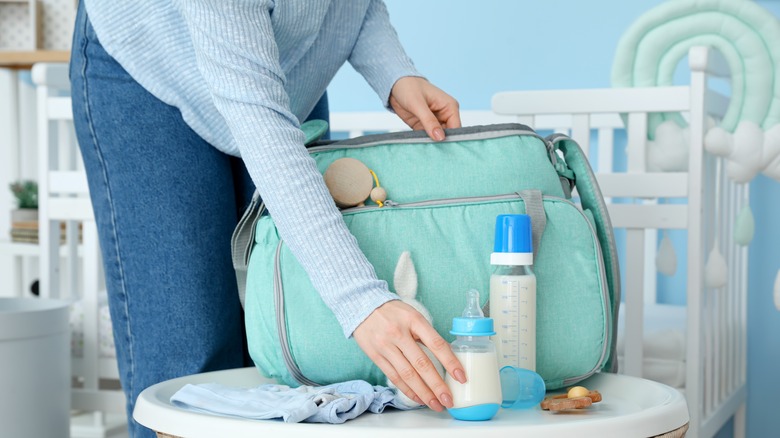 woman packing baby bottles