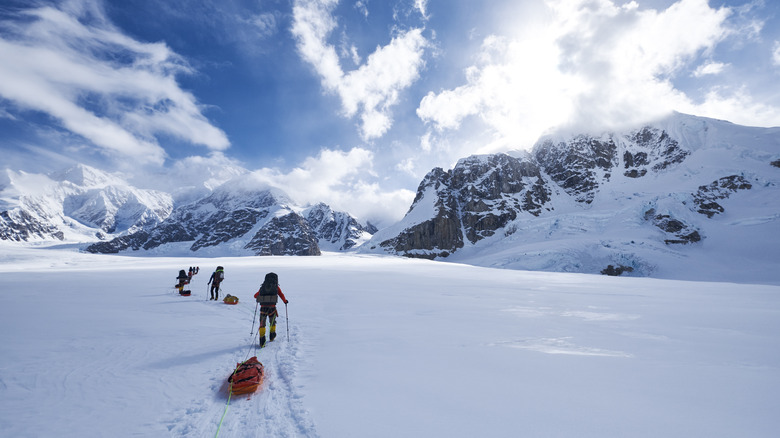 Hikers pulling rescue toboggan  