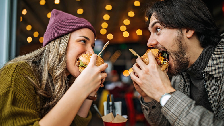 Couple eating burgers