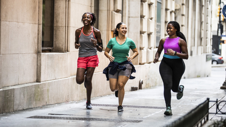 Group of women running in a city