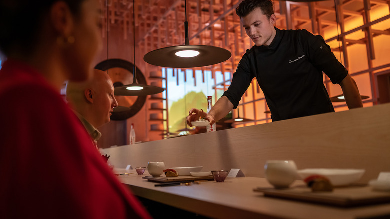 A server presents small plates at the Eatrenalin restaurant