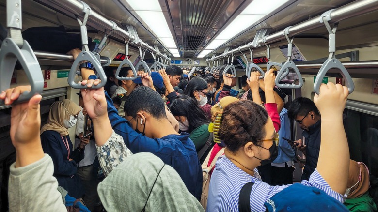 People standing crowded commuter train Japan