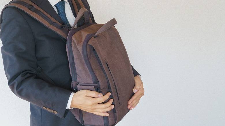 Businessperson wearing backpack in front