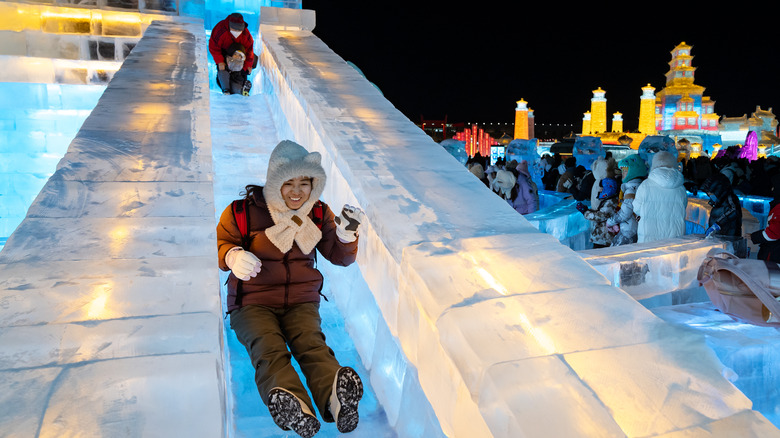 Visitors riding an ice slide