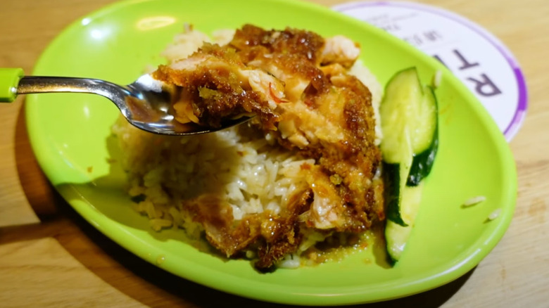 Chicken cutlet rice on green plate