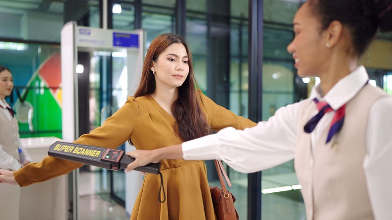 woman being scanned at airport