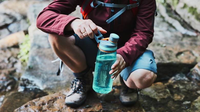 Hiker stopping to drink water