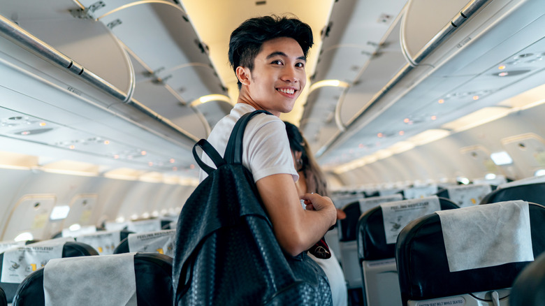 Traveler with backpack boarding plane