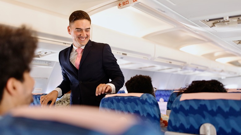 smiling flight attendant on plane