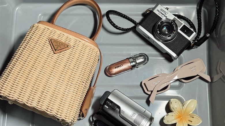 Purse camera and sunglasses in airport bin