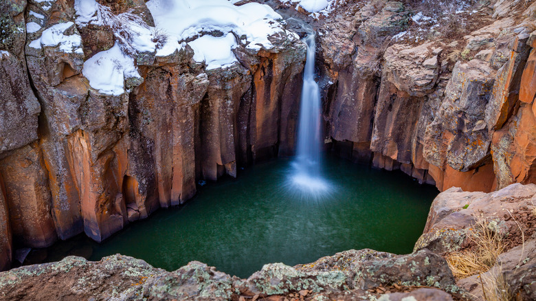 waterfall cascading over snowy cliffs