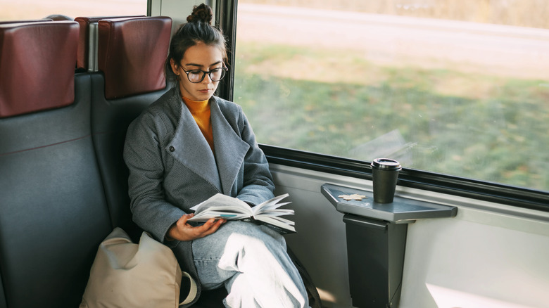 Woman reading on train