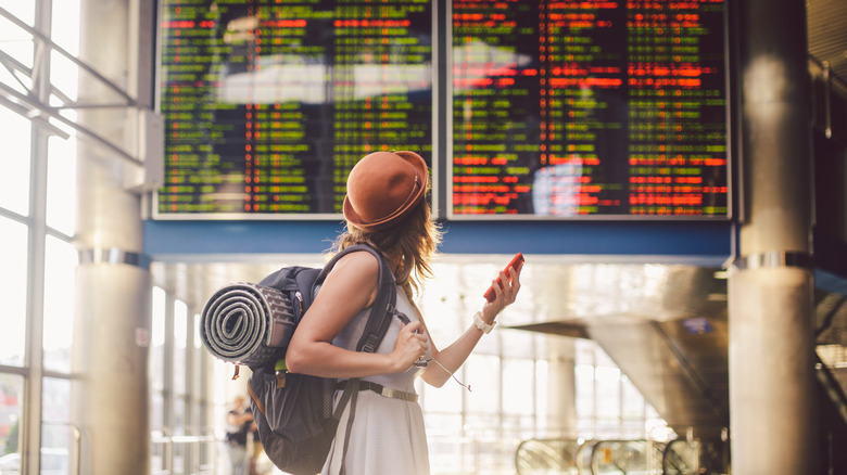 Woman looking at train schedule 