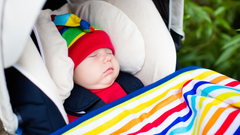 baby in carseat with blanket