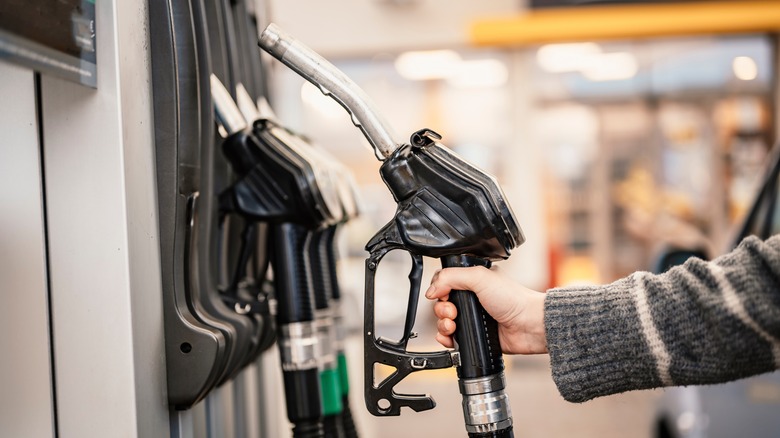 person at gas pump