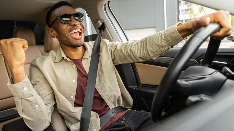 man singing in car