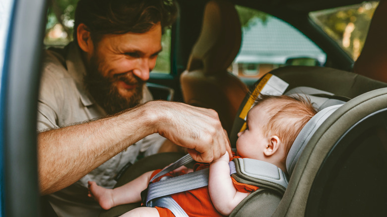 man in backseat with baby