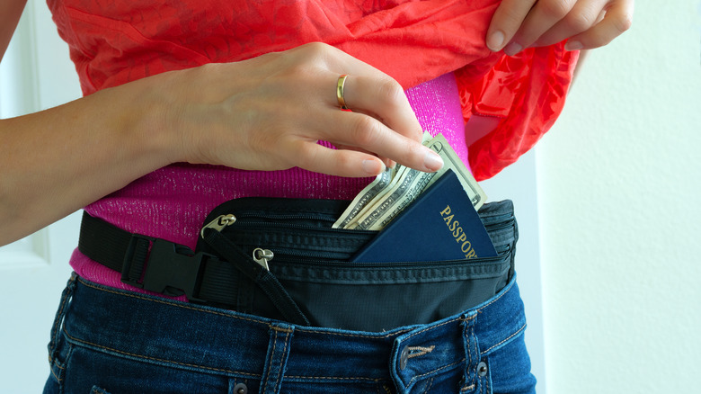 Person with passport and money in a money belt