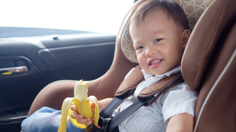 toddler in car with banana