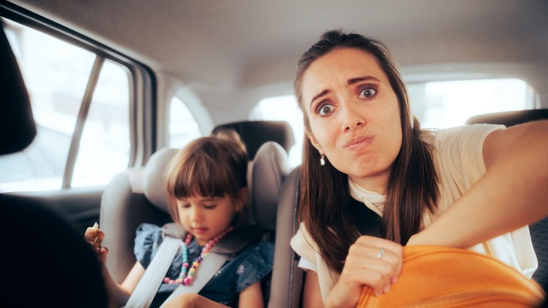 mom frustrated in car with toddler