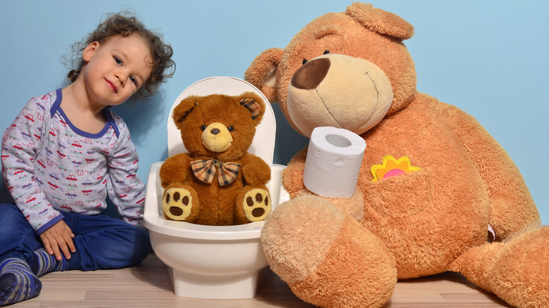 toddler with toys potty training