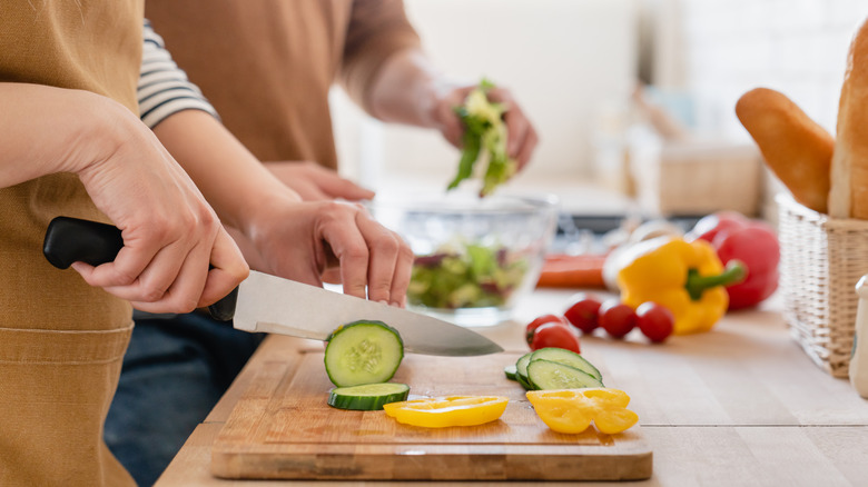 Person cutting vegetables