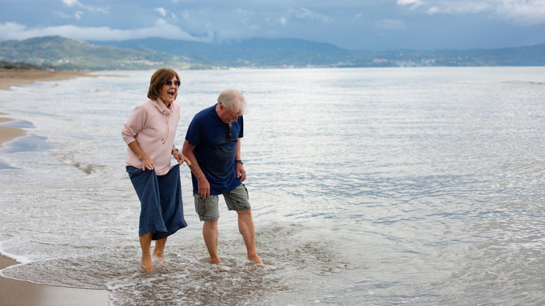 A couple wades in Mediterranean waters