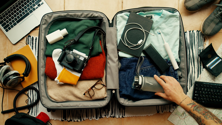 Man packing suitcase for vacation