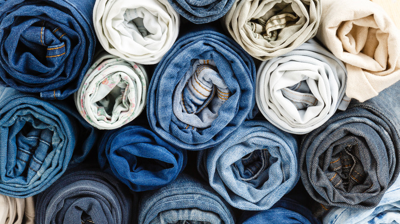 Many pairs of rolled jeans