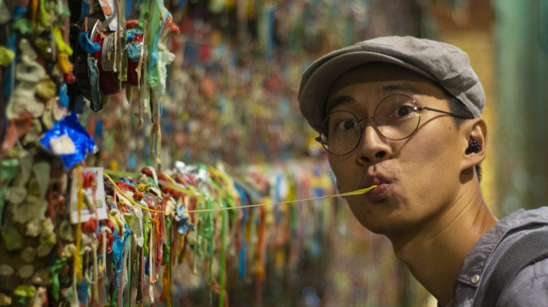 Tourist chewing the Gum Wall