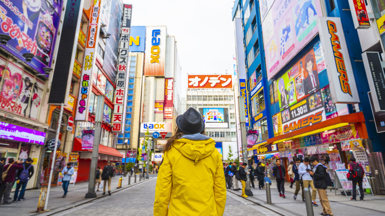 woman looking up on street in Akihabara