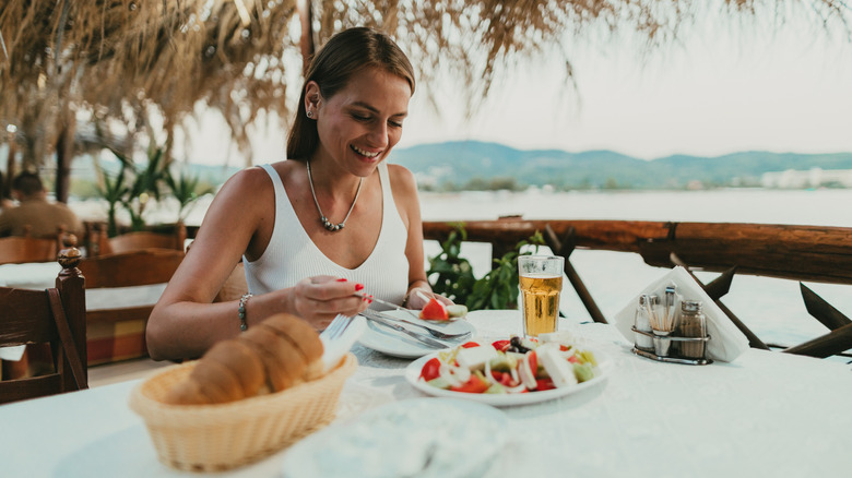 Traveler enjoying Greek salad outdoors