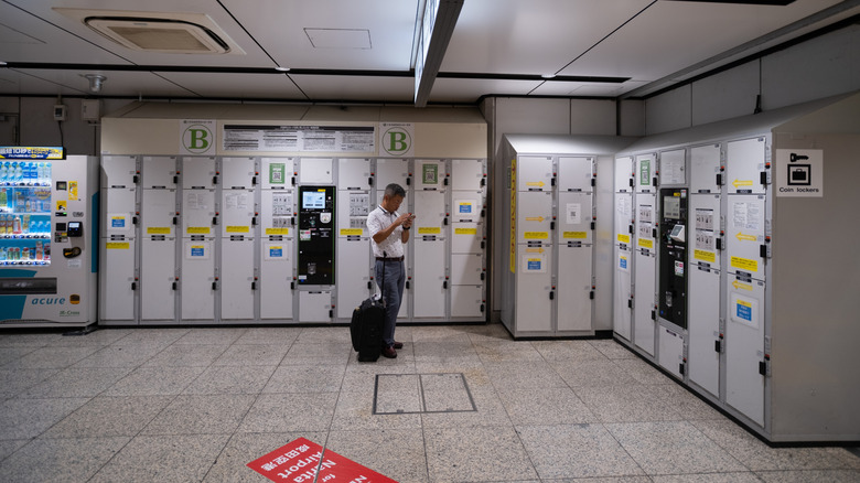 Man with luggage at a luggage storage in Japan